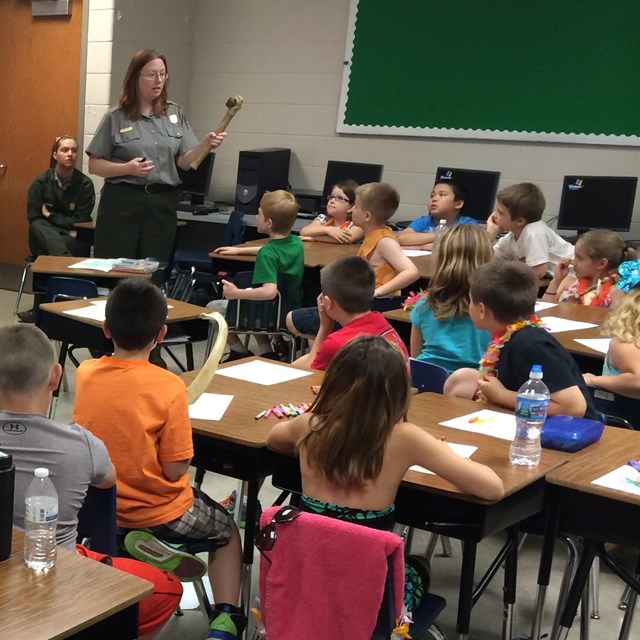 A ranger talks to a class of students
