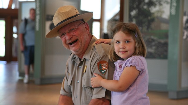 A park ranger with a young visitor.