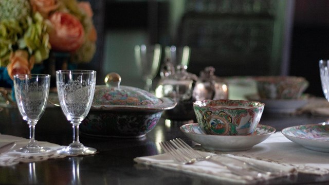 A table set with fine china and crystal.