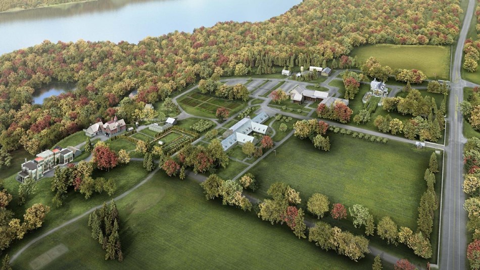 A birds eye view of a property with buildings and gardens along the banks of a river.