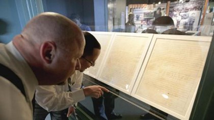Two people looking at the Homestead Act