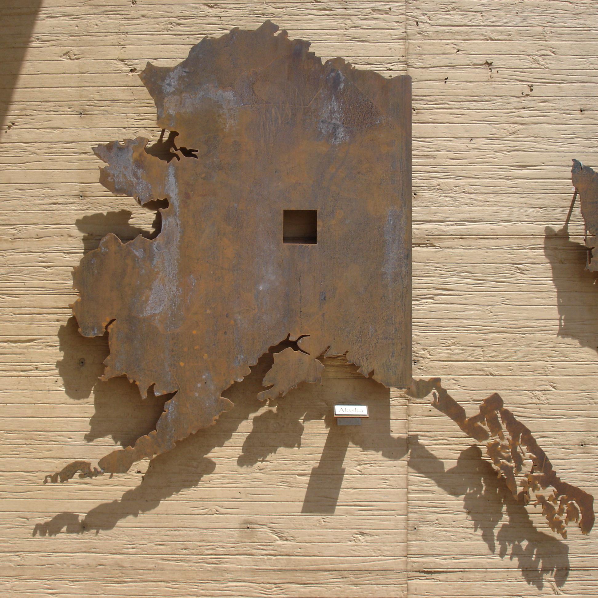 Cutout in the shape of Alaska with a cutout showing the amount of homesteaded land