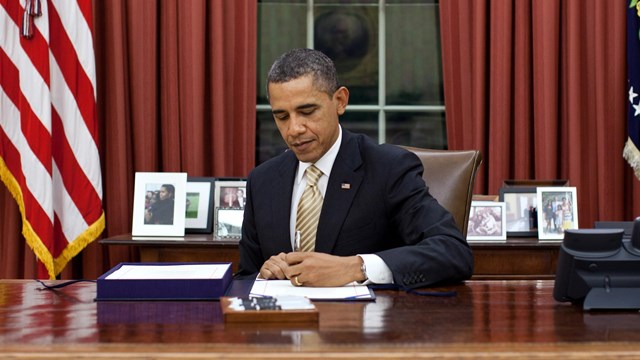 President Obama signing proclamation in the Whitehouse Oval Office