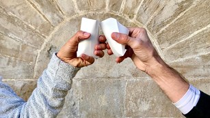 Two paper cups cheering above a shell fountain.