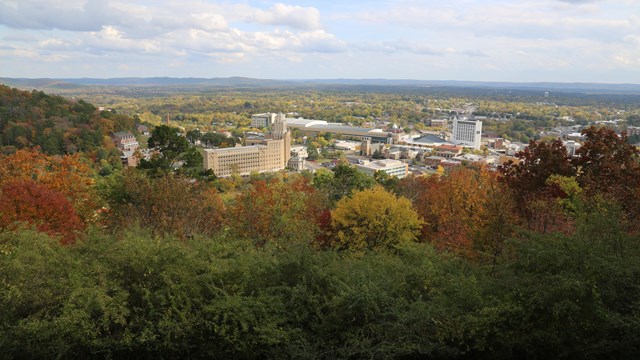 From West Mountain, looking over rolling hills, fall colors, and downtown Hot Springs.