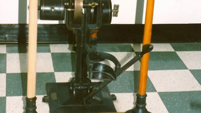 A machine for arm strengthening and chest enlarging, vertical bars with weights and pullies.