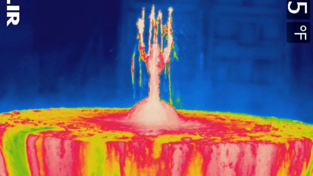 A thermal image of a fountain shows red, yellow, green, and blues where the water is hottest.