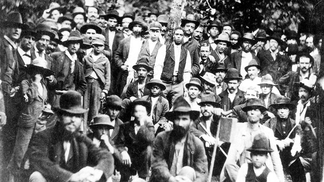 A black and white image of a large group of men.