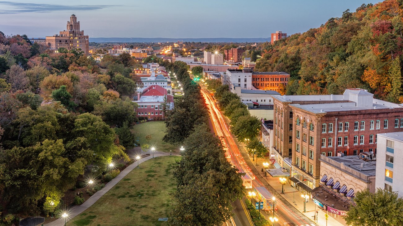 Aerial photograph of Central Ave in the evening. Car lights are streaking along the streets.