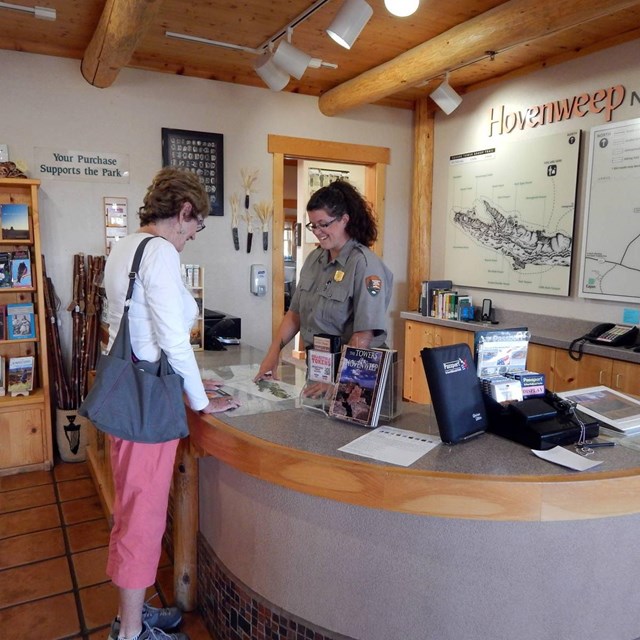 ranger helping visitor at front desk