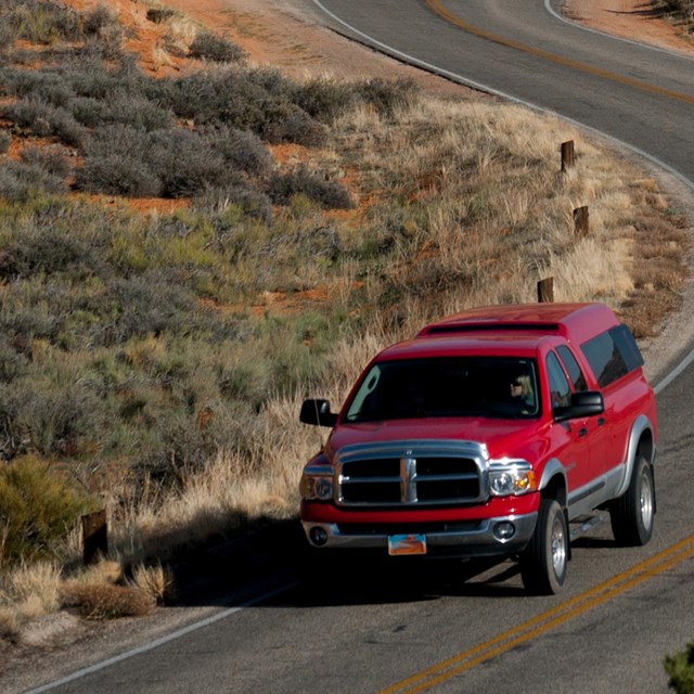 a red truck on a paved road