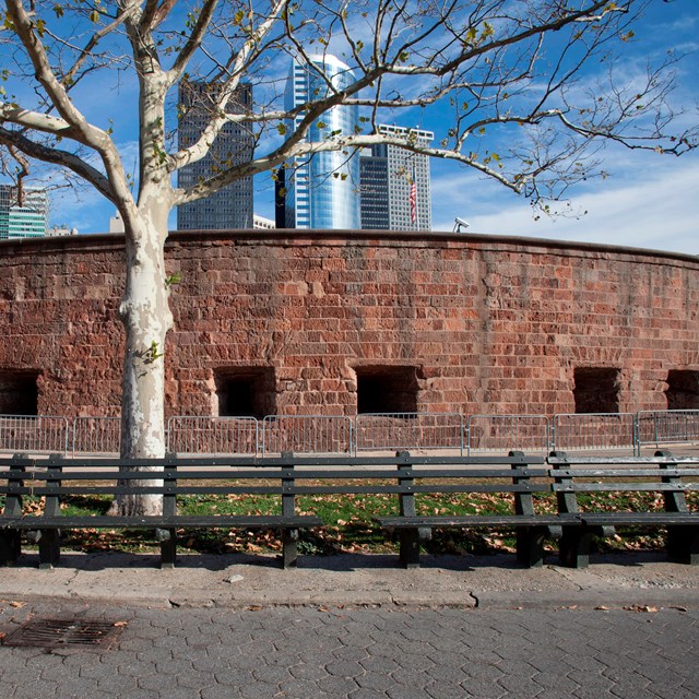 brick building with new york city buildings in the back