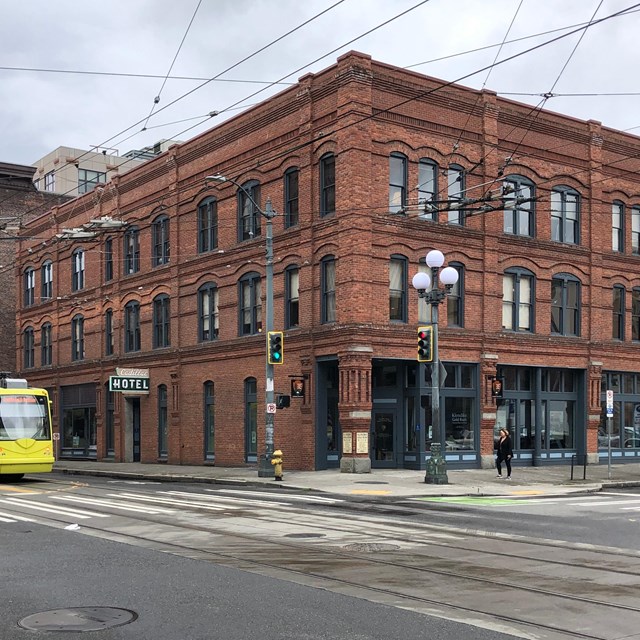 three-floored brick building on a corner of a street