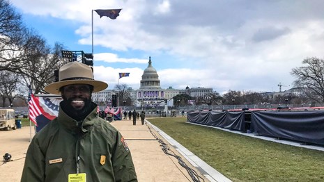 Park ranger with the U.S. Capitol building in the distance