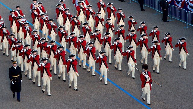 Military fife and drum core wearing traditional 18th-century uniforms