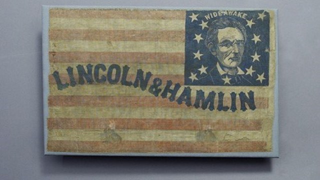 Historic campaign flag with an image of Abraham Lincoln and text reading "Lincoln & Hamlin"