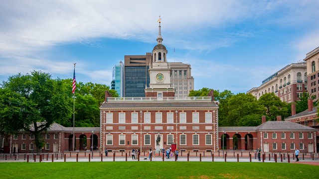 Independence Hall, a large brick building with a prominent cupola 