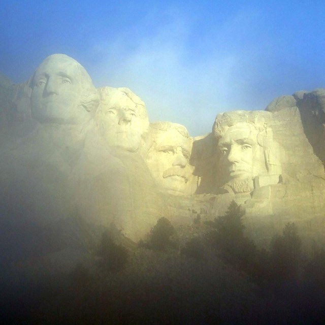 Presidents' faces on Mount Rushmore in fog