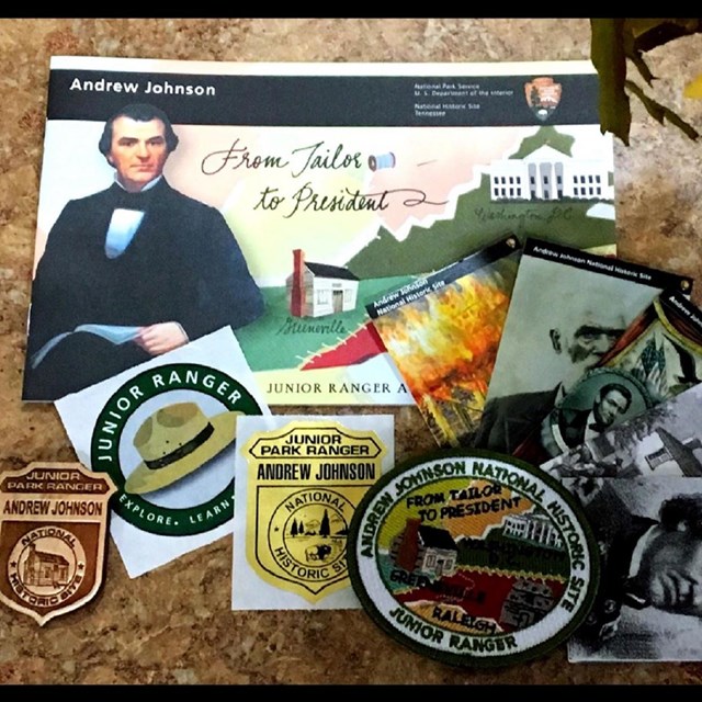 Cluster of Andrew Johnson themed Junior Ranger items, including a booklet, patches, and stickers