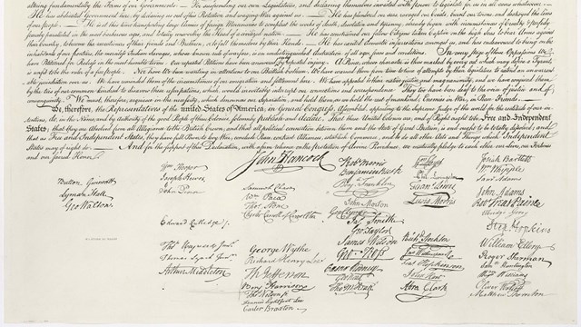 Color image of the bottom of the handwritten Declaration of Independence, showing the signatures.