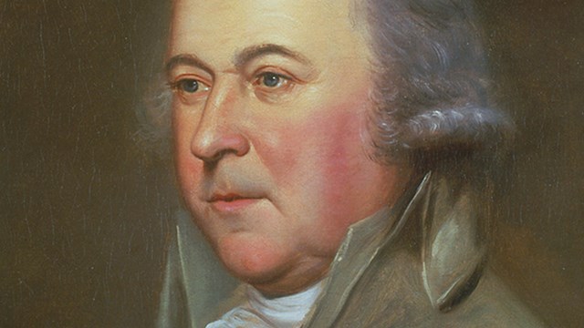 Color image of portrait of John Adams, showing man with gray hair in gray 18th century suit.