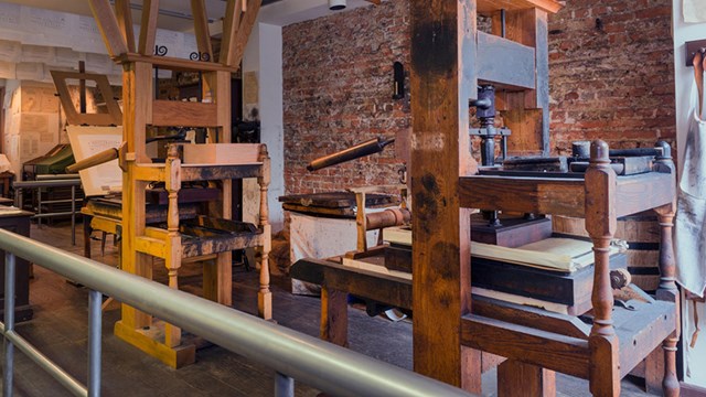Color photo showing two reproduction 18th century printing presses.