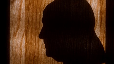 Color photo showing a silhouette of Benjamin Franklin in profile.