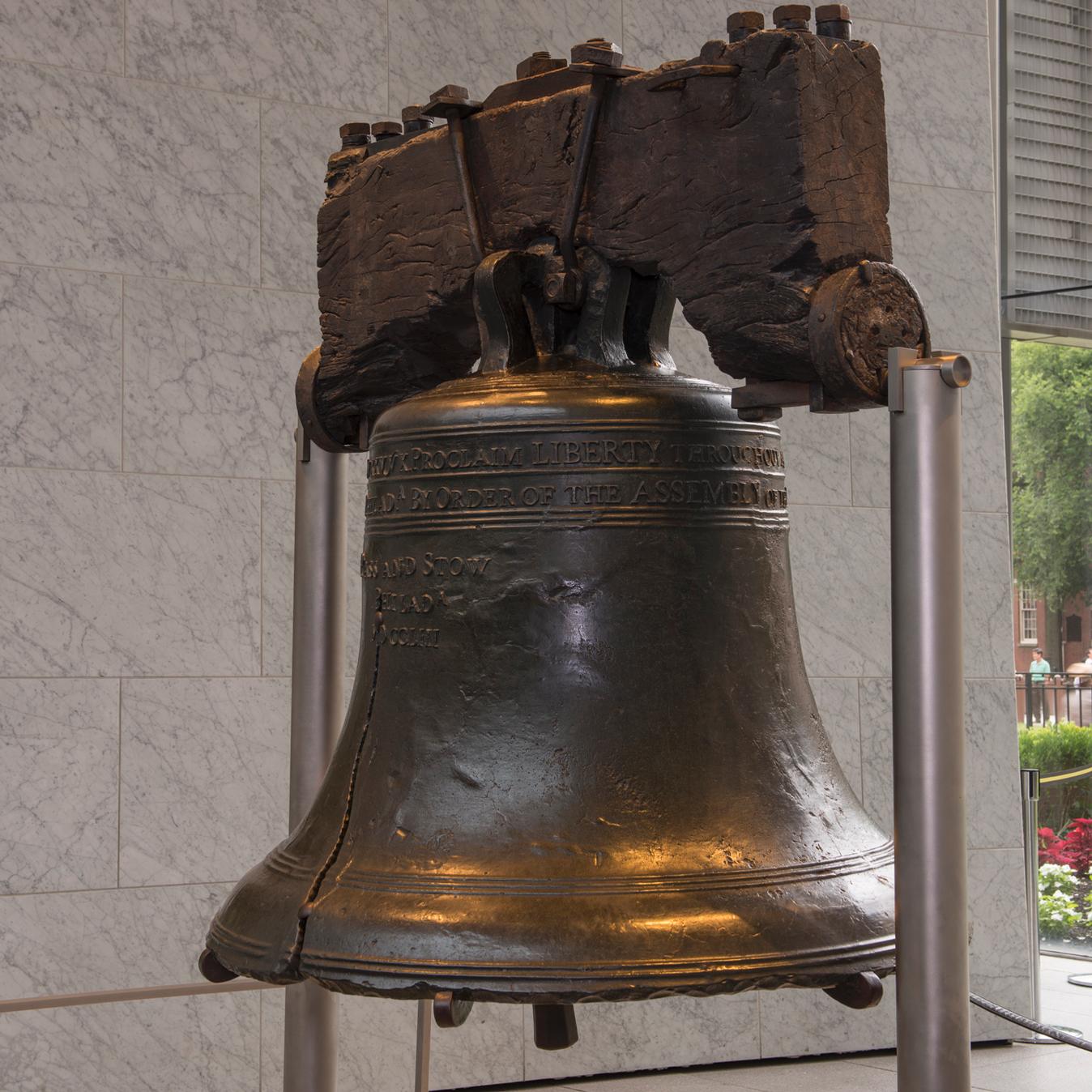 Color photo of the Liberty Bell, a bronze bell with wooden yoke.