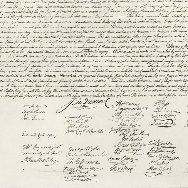 Color photo of bottom half of the Declaration of Independence, showing the signatures.