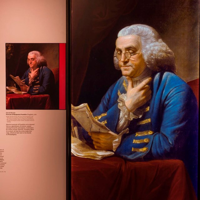 View of exhibit panel featuring portraits of Benjamin Franklin.