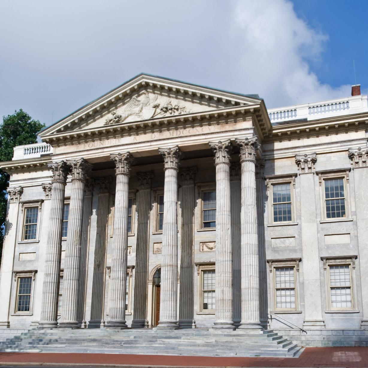 Two-story 18th century marble building with six columns and a pediment. 