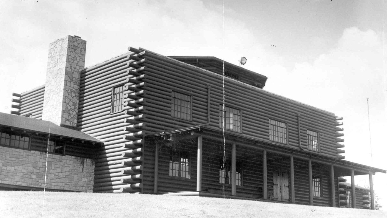 black and white photograph of log cabin style home