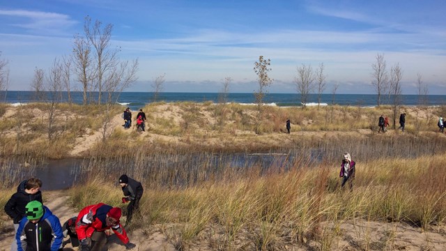 Students meandering a swale between two beach ridges along Lake Michigan