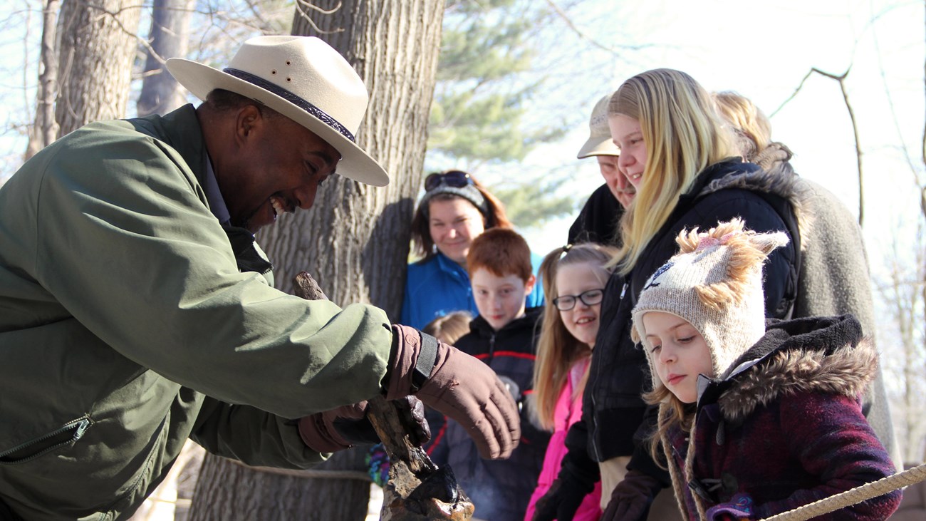 Ranger Kip showing visitors the art of making maple sugar. 