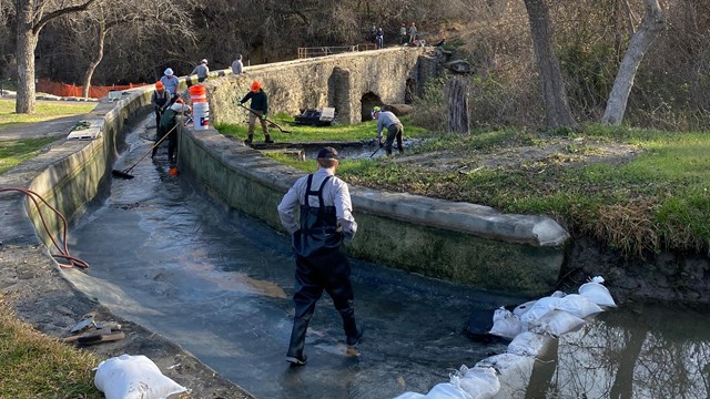 Construction crews working on a trail and bridge 