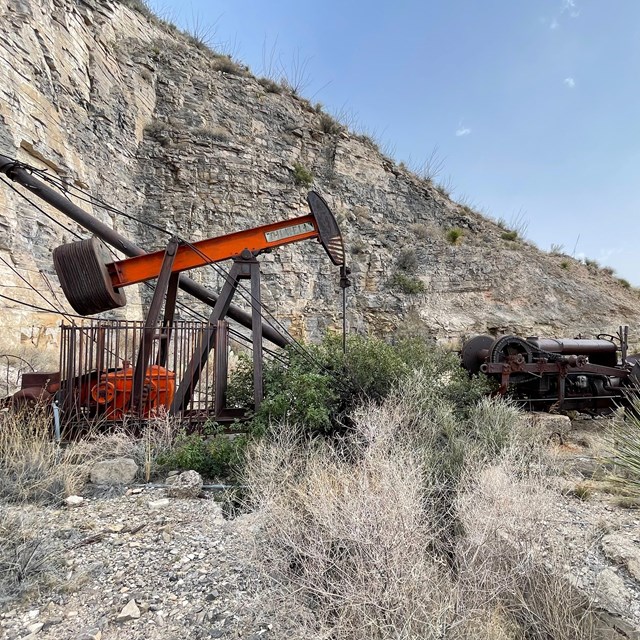 Old oil well on a desert canyon wall