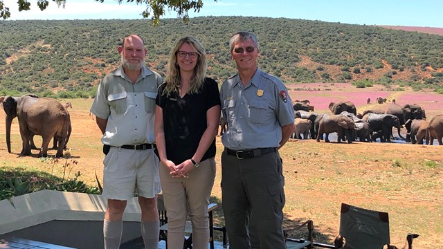 A National Park Service superintendent stands with park staff at Addo Elephant Park in South Africa.