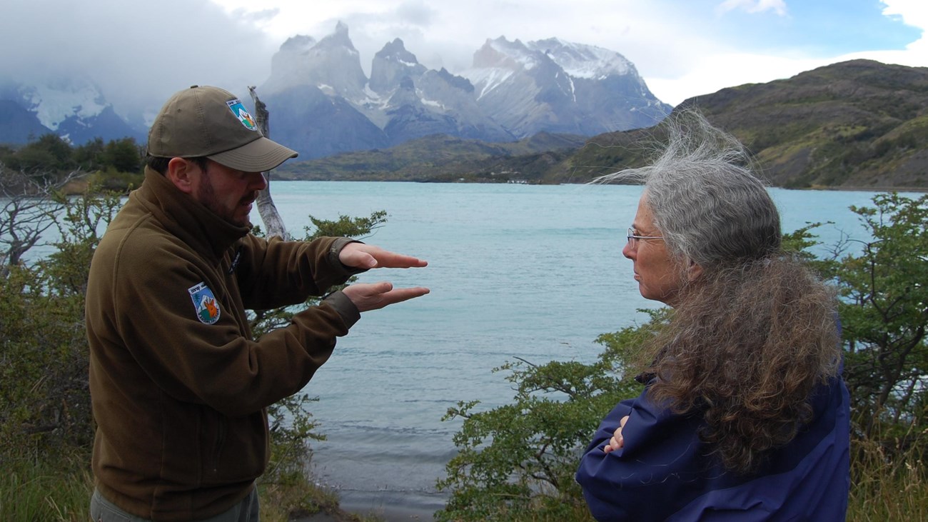 NPS and Chile park staff meet in front of a lake at Tores del Paine National Park, Chile. 