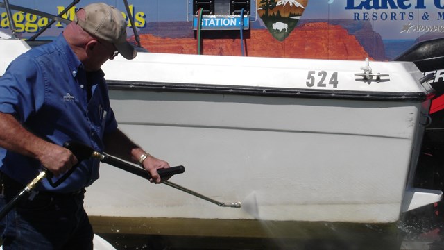 Man sprays down his water craft with high powered water