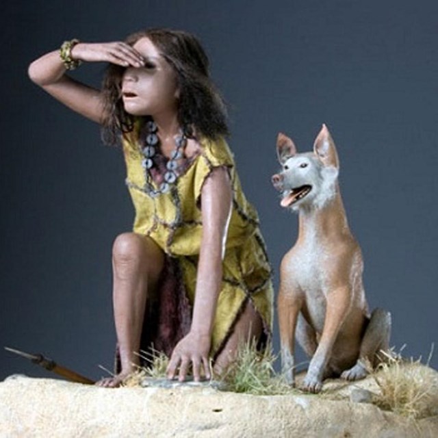 A miniature model of a native american indian girl with dog. 