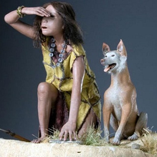 A miniature model of a native american indian girl with dog. 