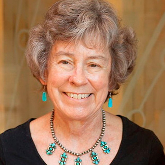 Woman with black shirt and necklace. 