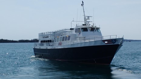 A large ferry boat called 'Isle Royale Queen IV' on open water