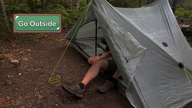 A person exits a tent.