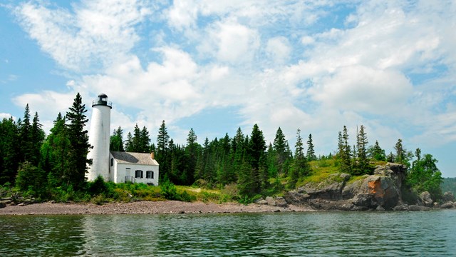 view of lighthouse from Middle Islands Passage on a blue sky day