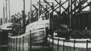 SS Chisholm docked behind another vessel