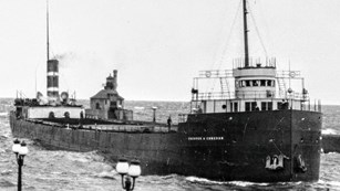 SS Congdon arriving to a harbor with lamps shining on the left side