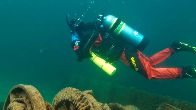 a diver explores shipwrecks
