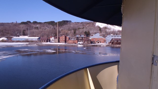 View of the Quincy Smelter from the Ranger III across the icy spring water of the Keweenaw Waterway.