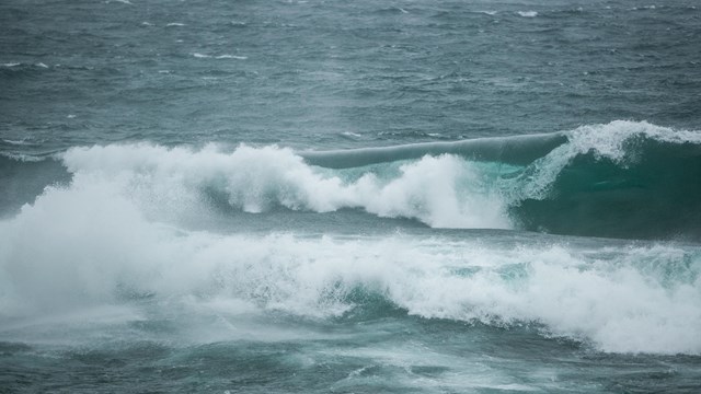 White-capped waves crash in the water.